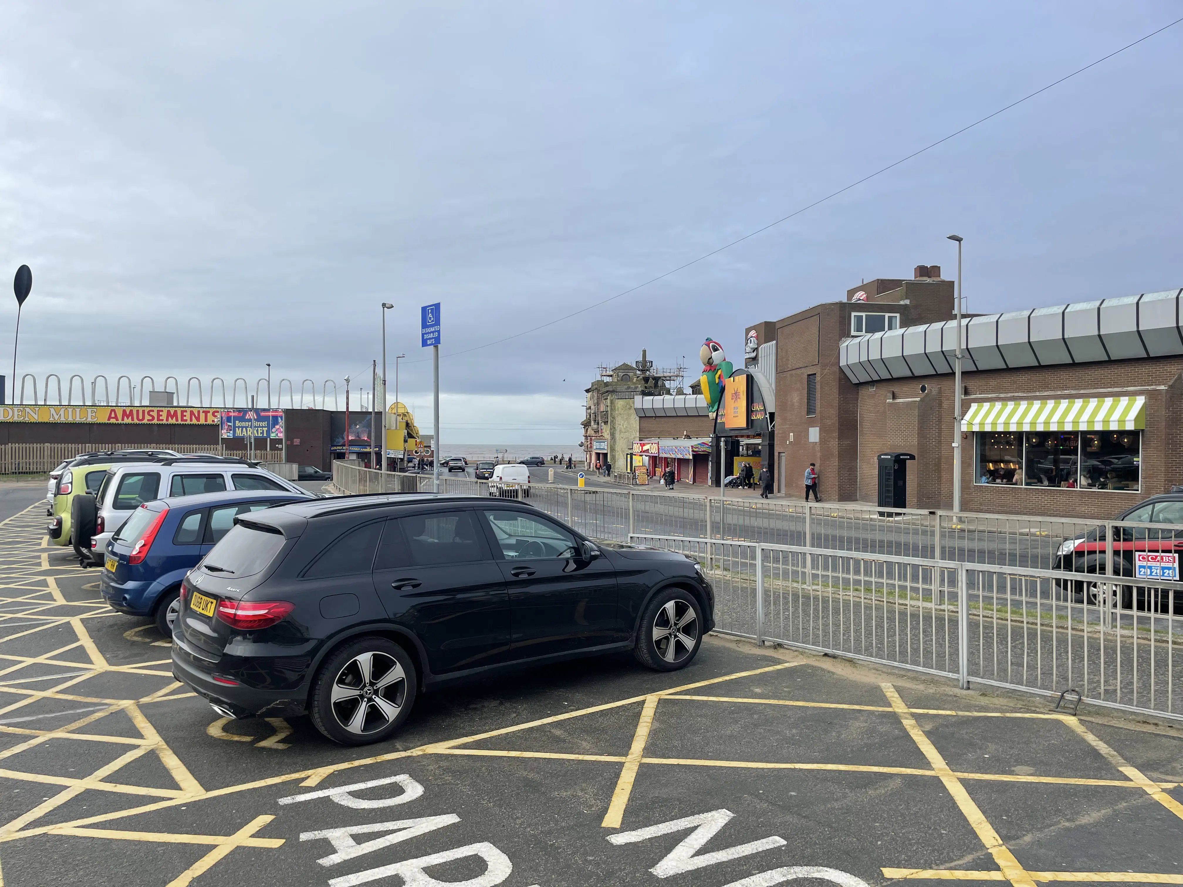 Cars parked opposite Coral Island